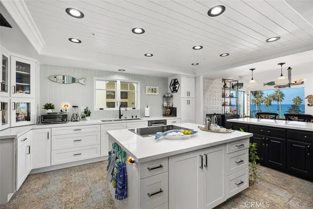 a kitchen that has a sink and a stove in it