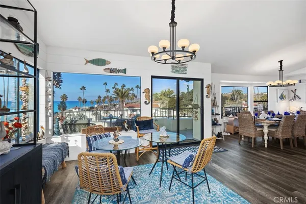 a view of a dining room with furniture wooden floor and chandelier