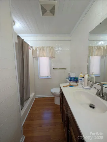 a bathroom with a sink a toilet a mirror and vanity