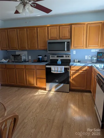 a kitchen with stainless steel appliances a stove a sink and a microwave