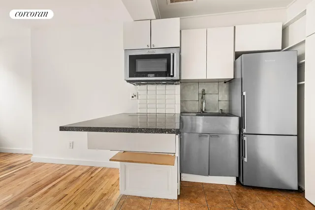 a kitchen with stainless steel appliances a refrigerator and a stove top oven