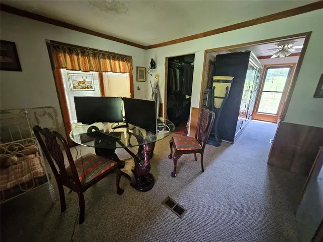 a view of a workspace with furniture and a window