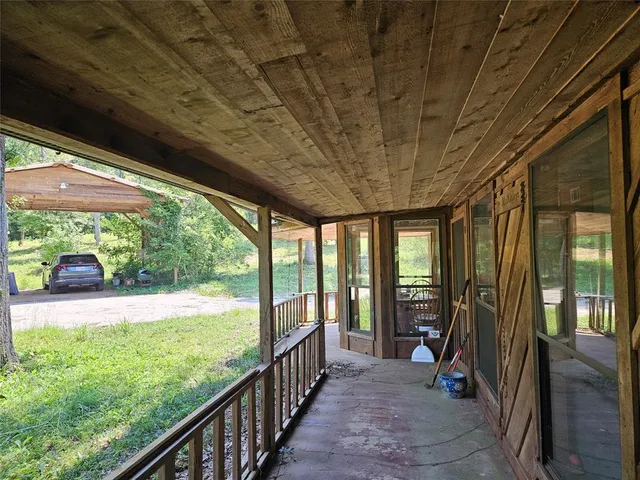 a view of hallway with a large window and swimming pool