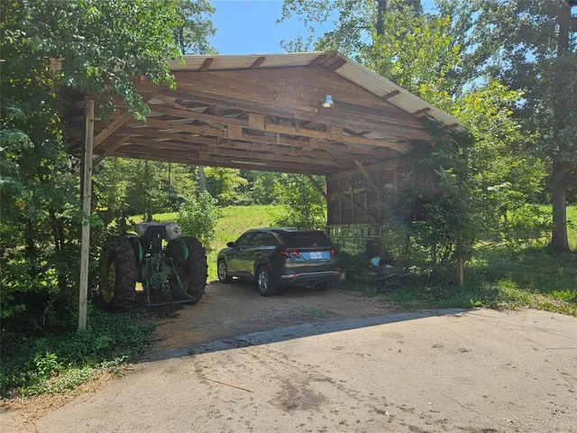 a view of a street with a large tree