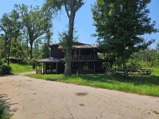 a view of a house with garden and trees