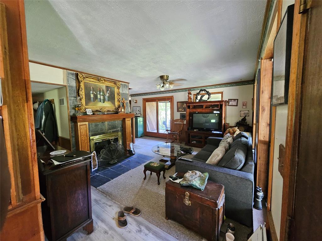 16307 County Road Henderson, TX 75654 - Photo 4 of 27 a living room with furniture a flat screen tv and a refrigerator