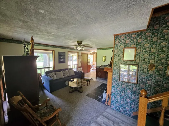 a living room with furniture a chandelier and a window