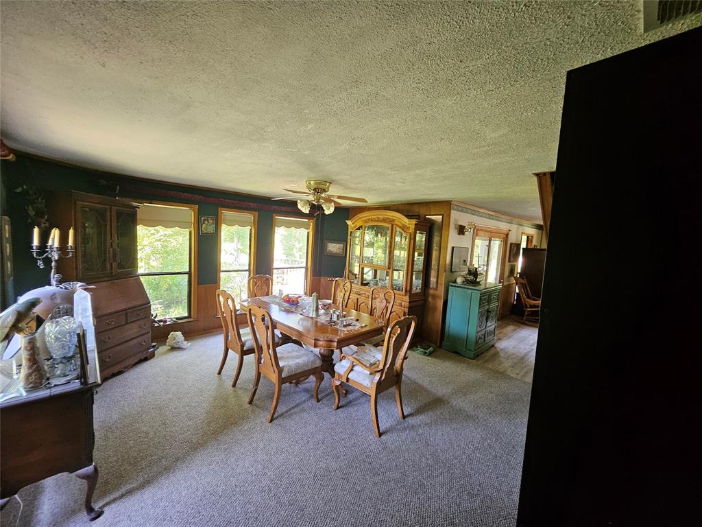 16307 County Road Henderson, TX 75654 - Photo 7 of 27 a dining room with furniture and a floor to ceiling window