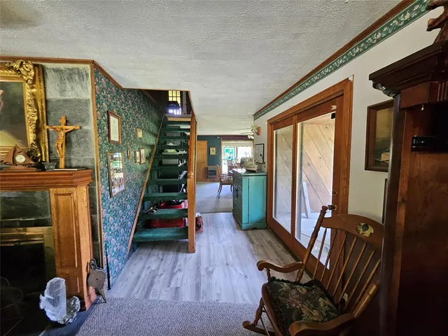 a view of an entryway with wooden floor