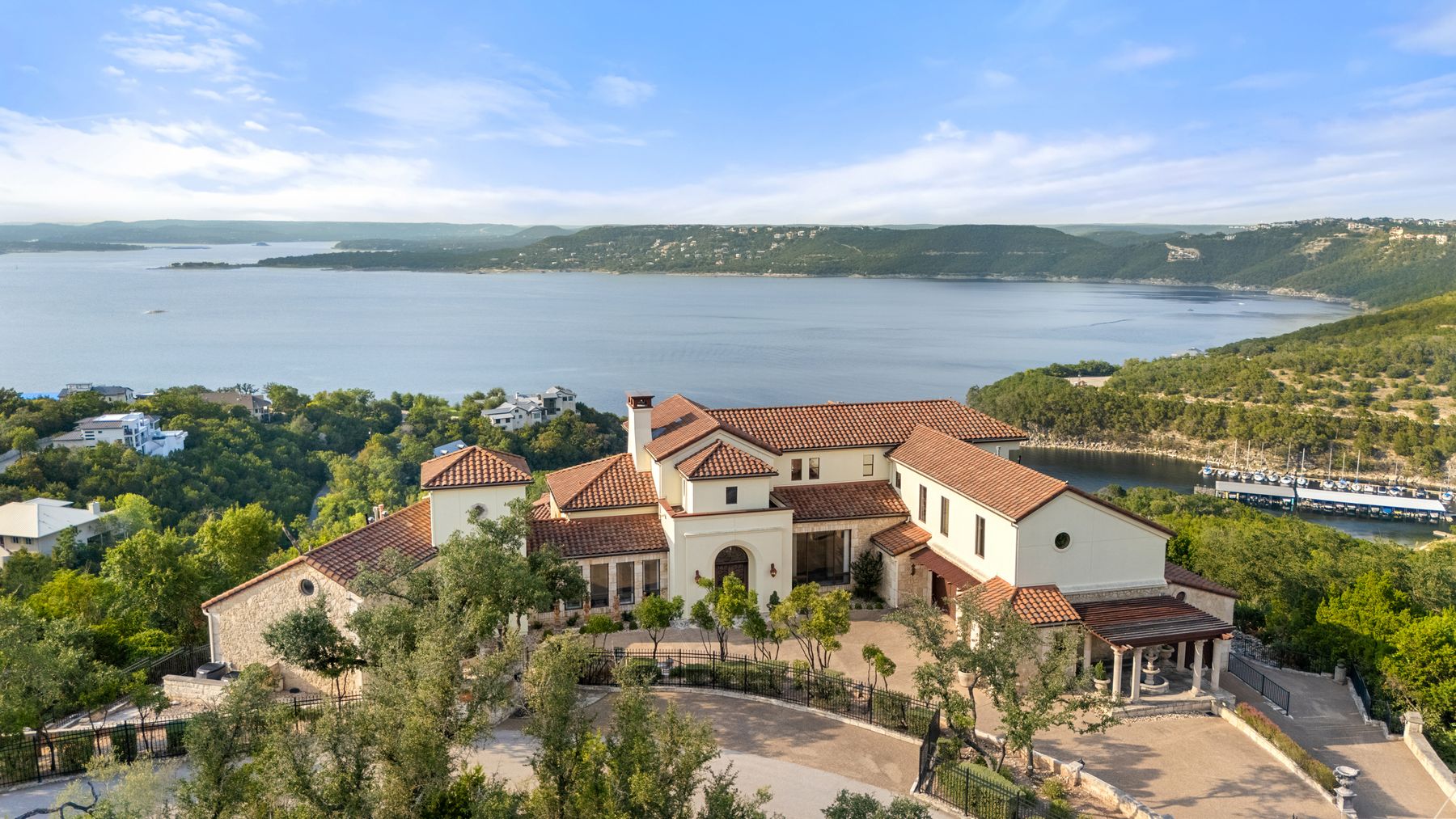 an aerial view of a house with a garden and lake view