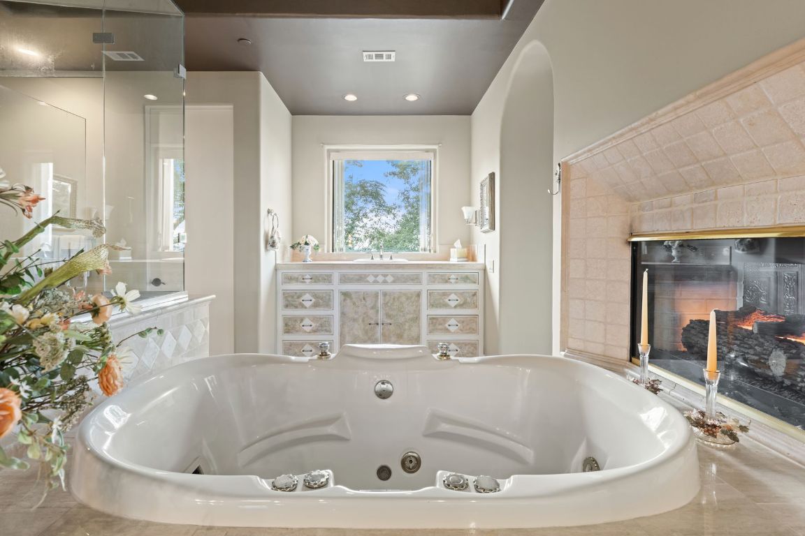 12600 Lyndon Drive Austin, TX 78732 - Photo 15 of 37 a bathroom with bathtub and window