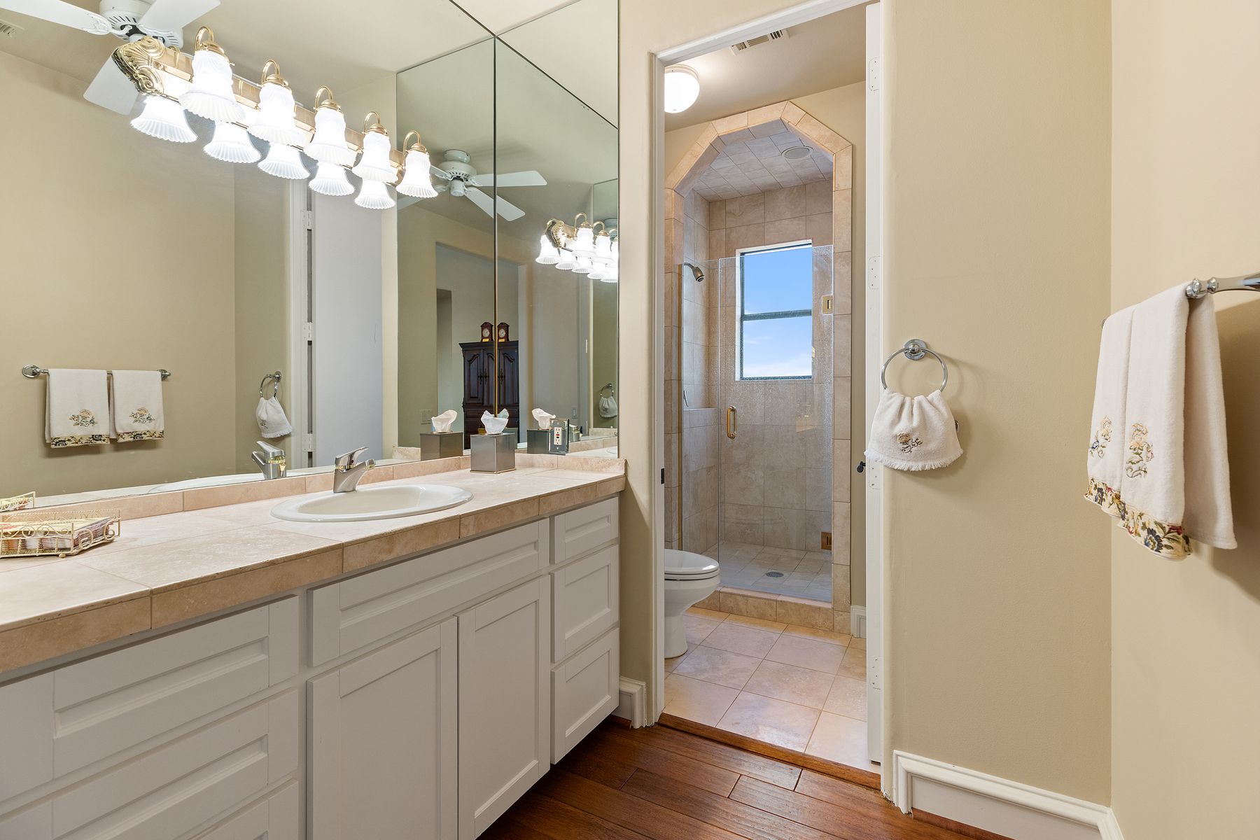 12600 Lyndon Drive Austin, TX 78732 - Photo 23 of 37 a bathroom with a granite countertop sink a mirror and a shower