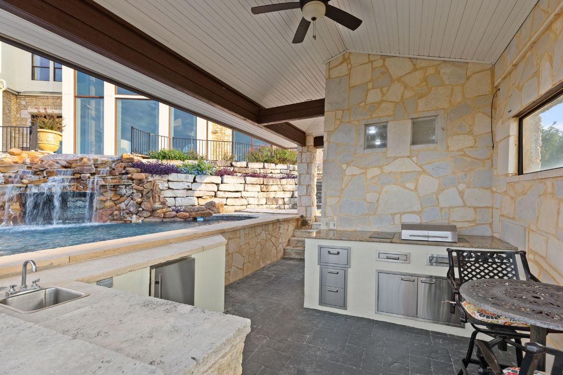 12600 Lyndon Drive Austin, TX 78732 - Photo 31 of 37 a kitchen with a sink stove and cabinets