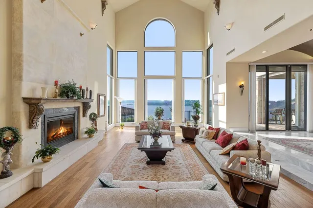 a living room with furniture fireplace and a large window