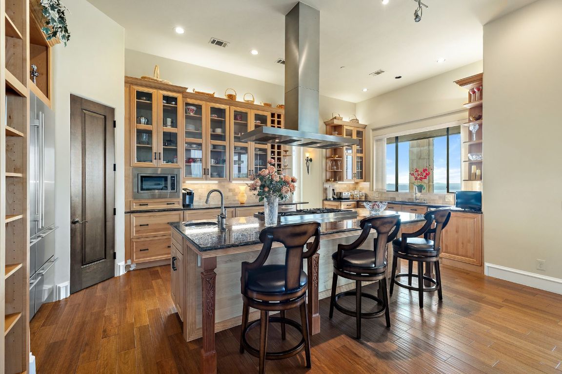 12600 Lyndon Drive Austin, TX 78732 - Photo 7 of 37 a view of a dining room with furniture and wooden floor
