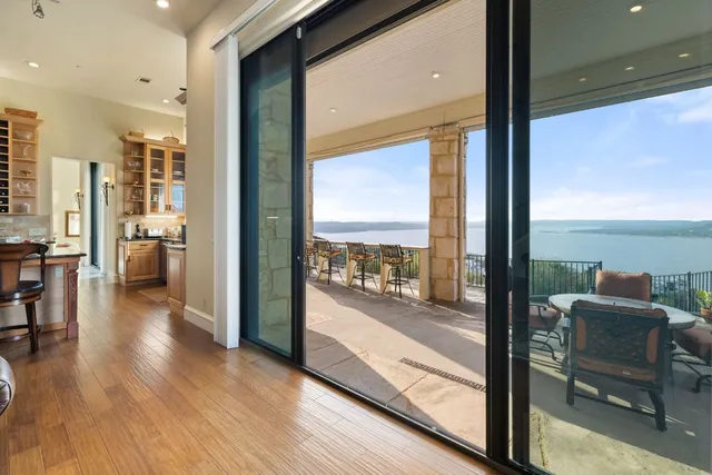 a view of a living room with furniture and floor to ceiling windows