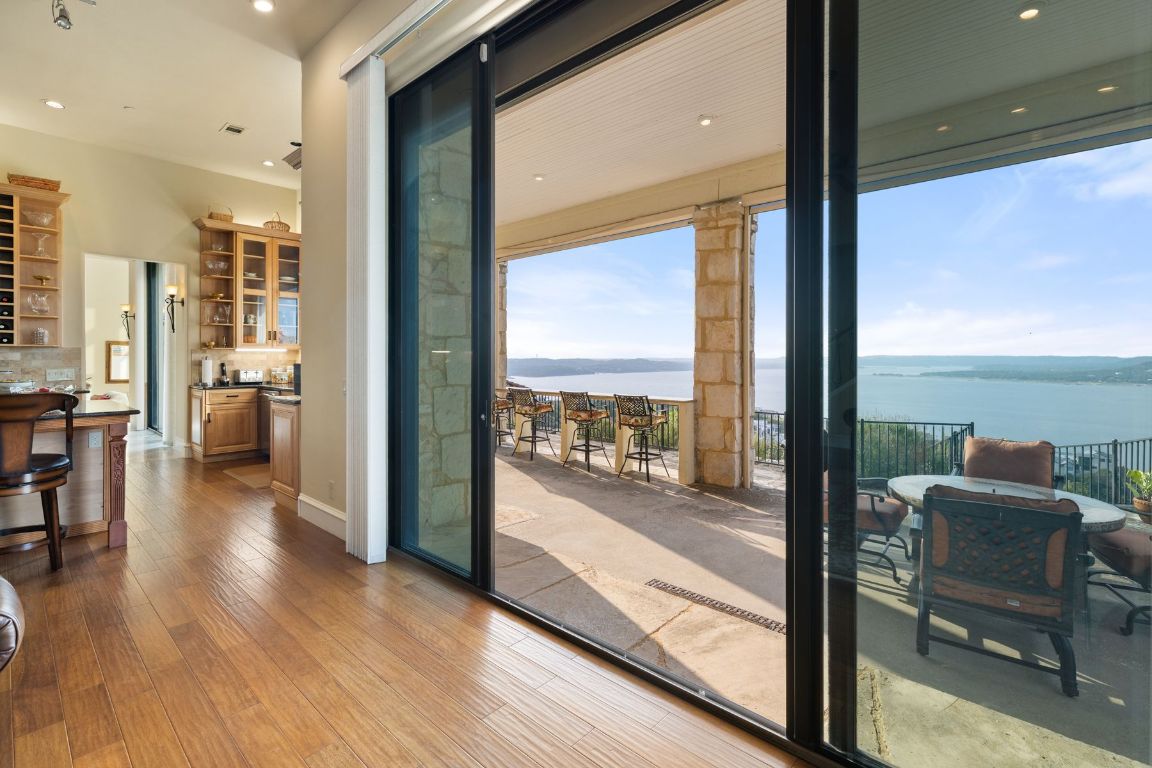 12600 Lyndon Drive Austin, TX 78732 - Photo 10 of 37 a view of a living room with furniture and floor to ceiling windows