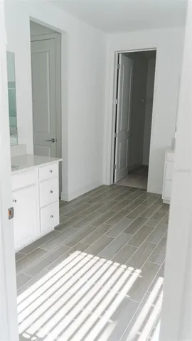 a view of a room with wooden floor and cabinet