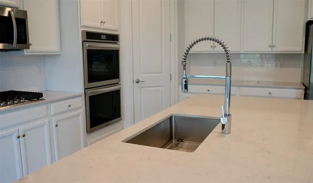 a kitchen with a refrigerator and a sink