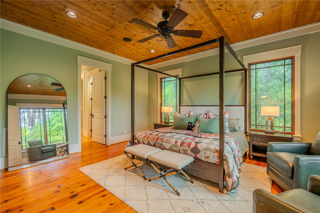 102 State Rd S-39-143 Sunset, SC 29685 - Photo 27 of 47 This spacious room features rich wood floors, a stylish ceiling, and large windows that invite abundant light.