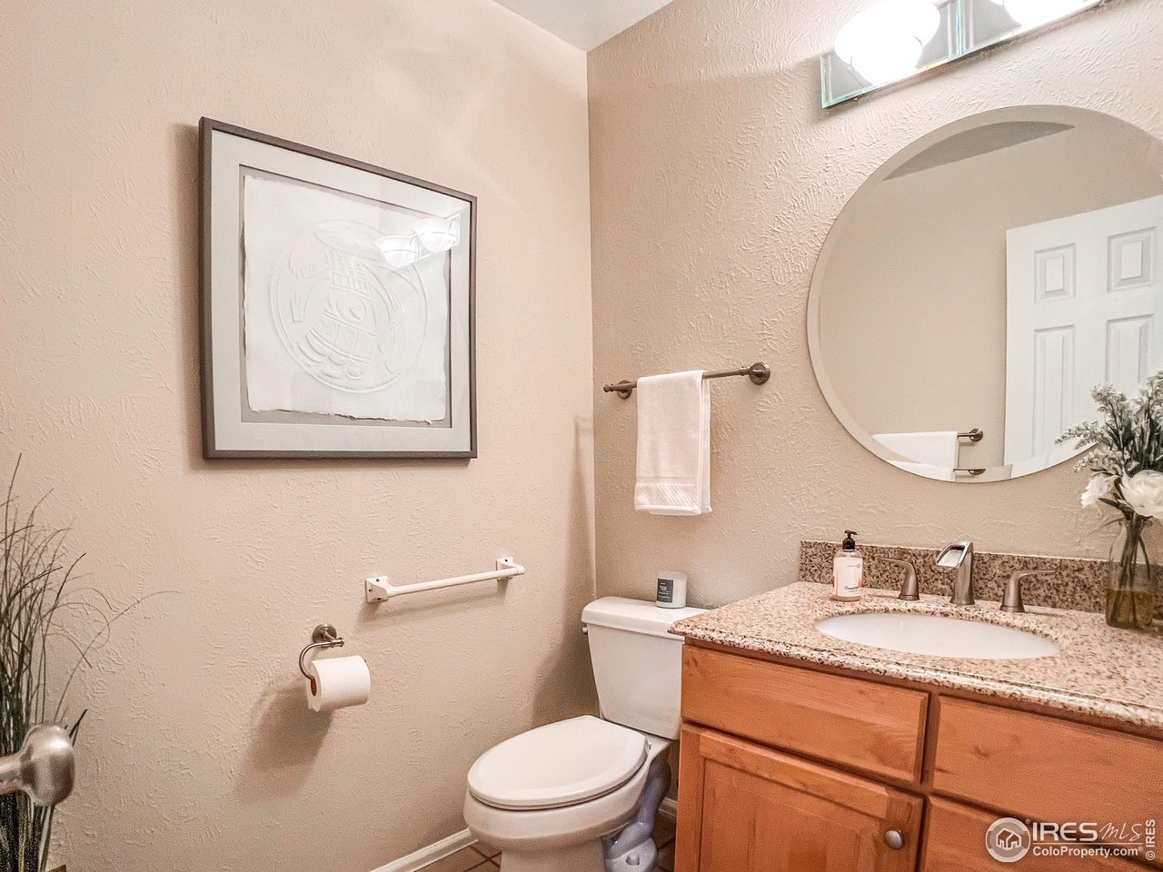 645 Cree Circle Boulder, CO 80303 - Photo 15 of 40 a bathroom with a granite countertop toilet a sink and mirror