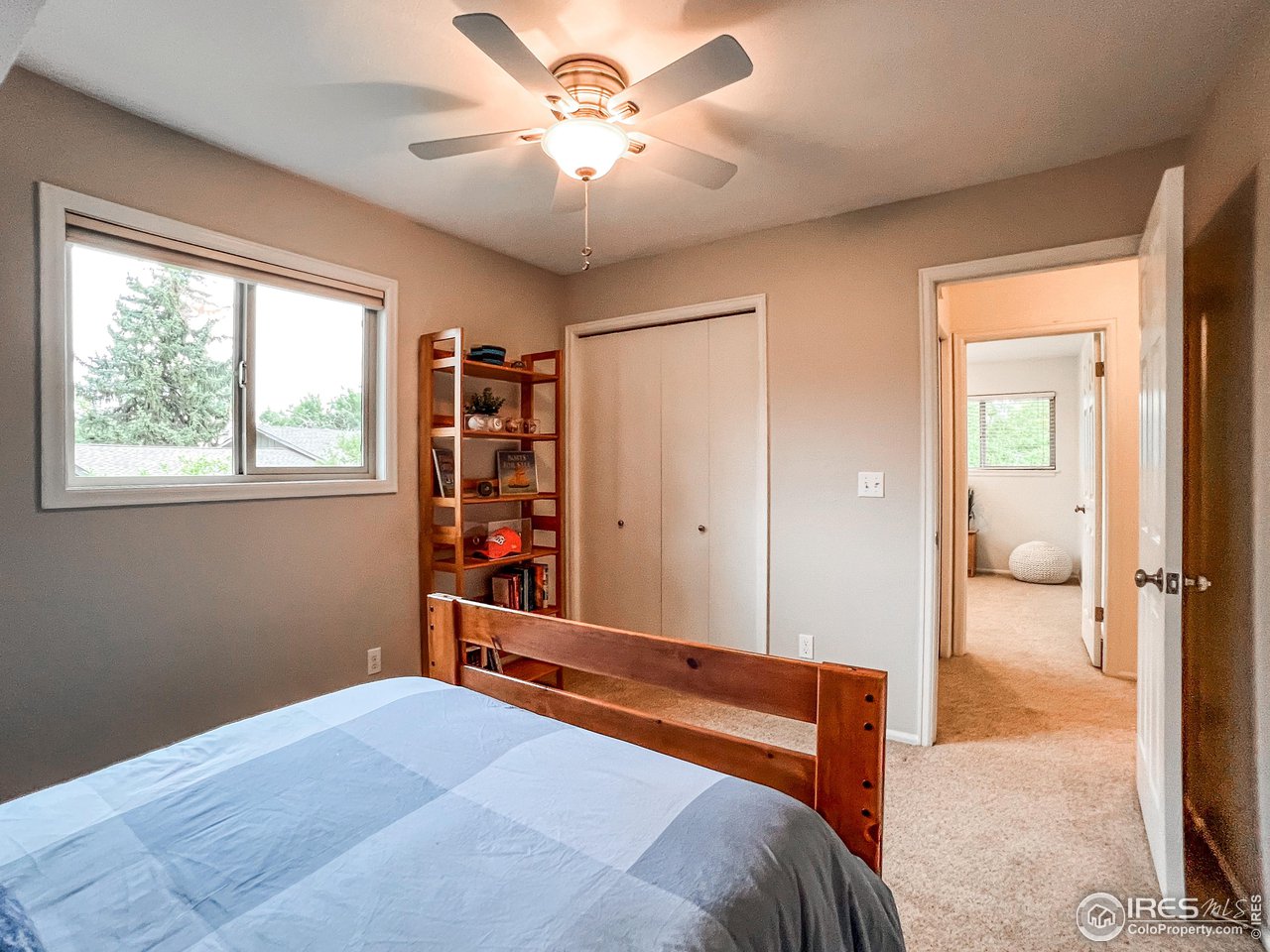 645 Cree Circle Boulder, CO 80303 - Photo 22 of 40 a bedroom with a bed and a chandelier