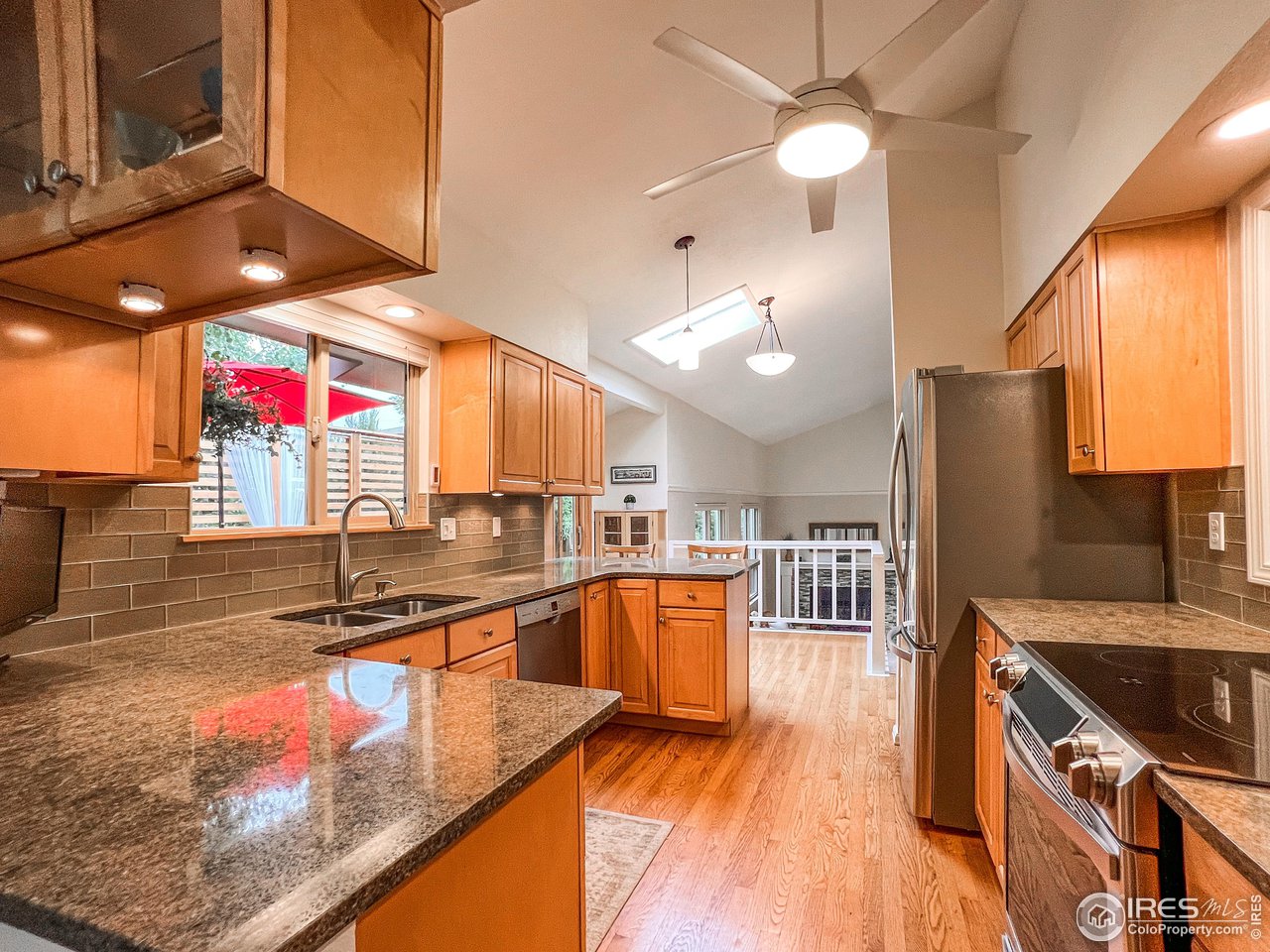 645 Cree Circle Boulder, CO 80303 - Photo 8 of 40 a kitchen with stainless steel appliances granite countertop a sink a stove and a wooden floors