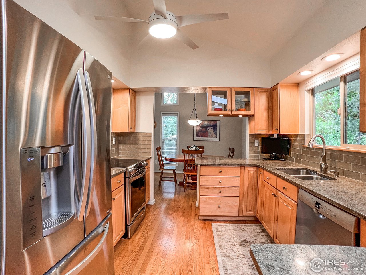 645 Cree Circle Boulder, CO 80303 - Photo 9 of 40 a kitchen with stainless steel appliances granite countertop a refrigerator a stove and a sink with cabinets