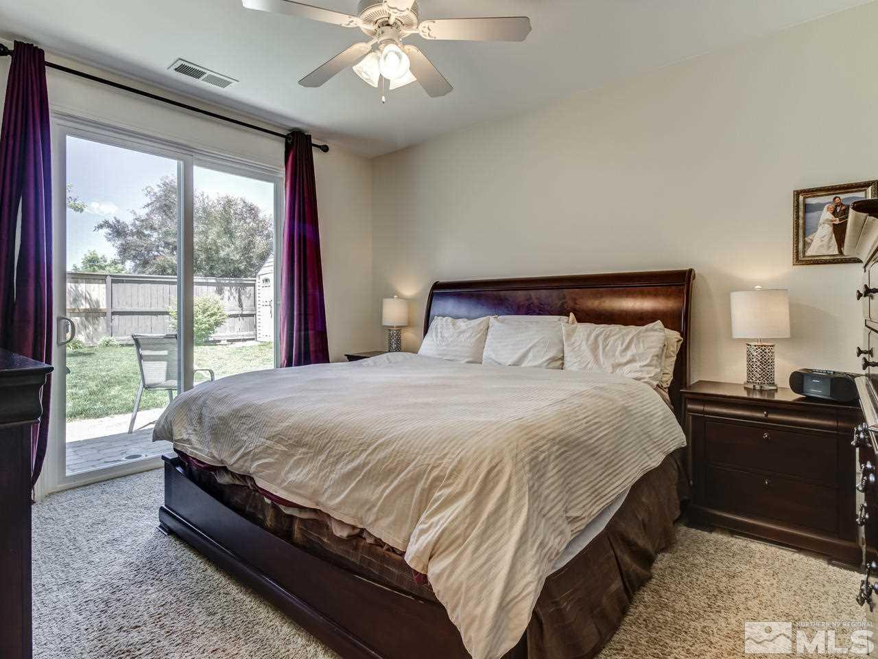 417 Alysheba Court Reno, NV 89521 - Photo 11 of 25 a large bed sitting in a bedroom next to a window
