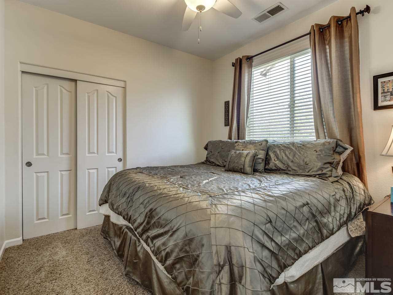 417 Alysheba Court Reno, NV 89521 - Photo 14 of 25 a bedroom with a bed and a window