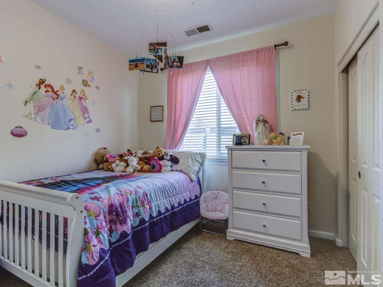 417 Alysheba Court Reno, NV 89521 - Photo 17 of 25 a bedroom with a bed and a window