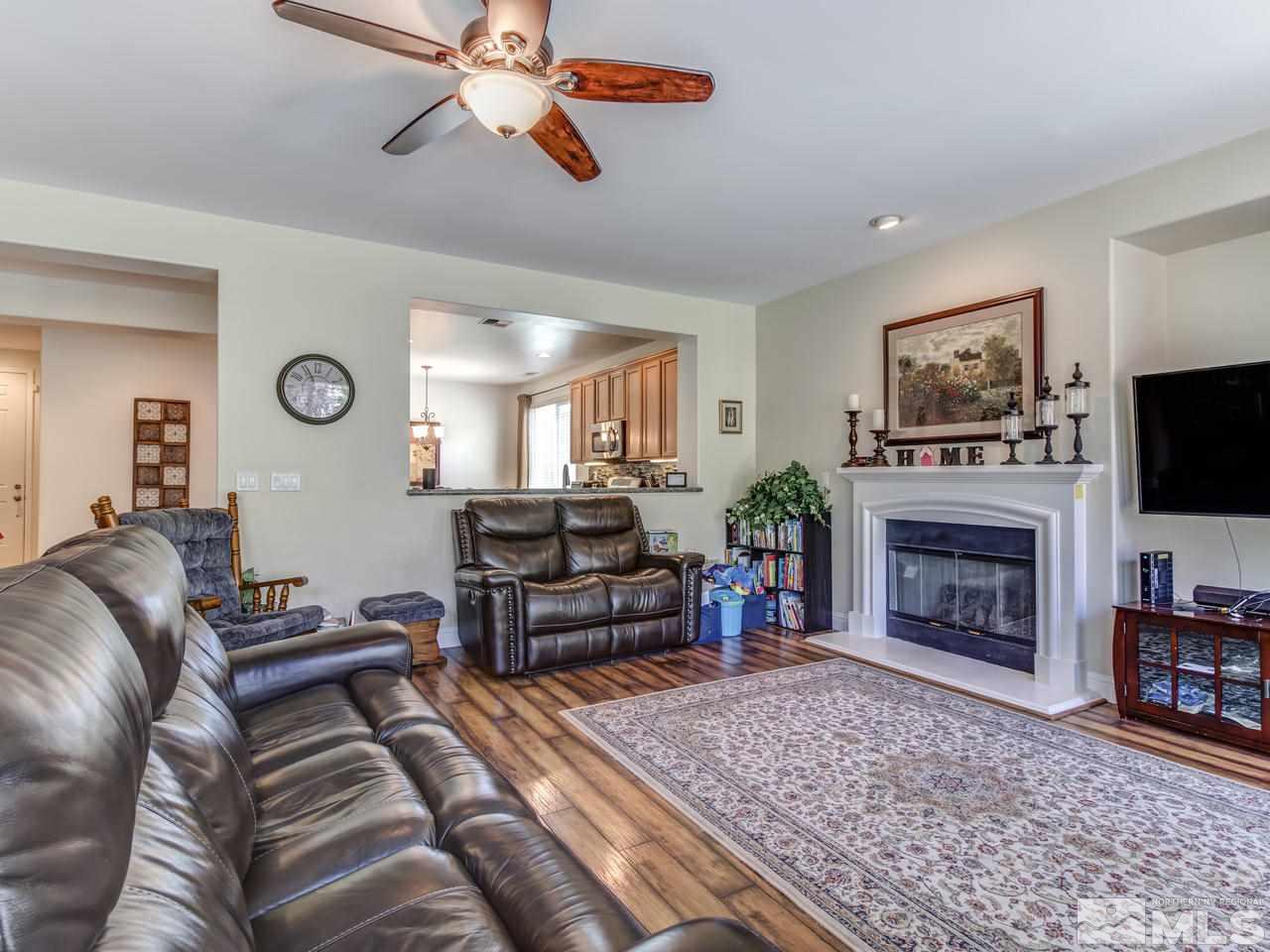 417 Alysheba Court Reno, NV 89521 - Photo 7 of 25 a living room with furniture a fireplace and flat screen tv