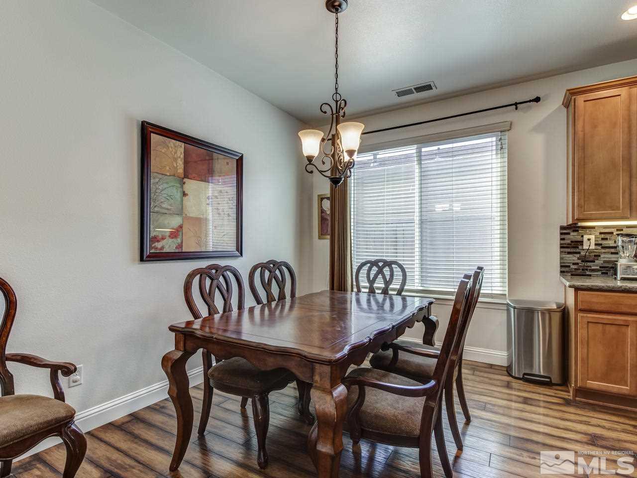 417 Alysheba Court Reno, NV 89521 - Photo 10 of 25 a view of a dining room with furniture window and wooden floor