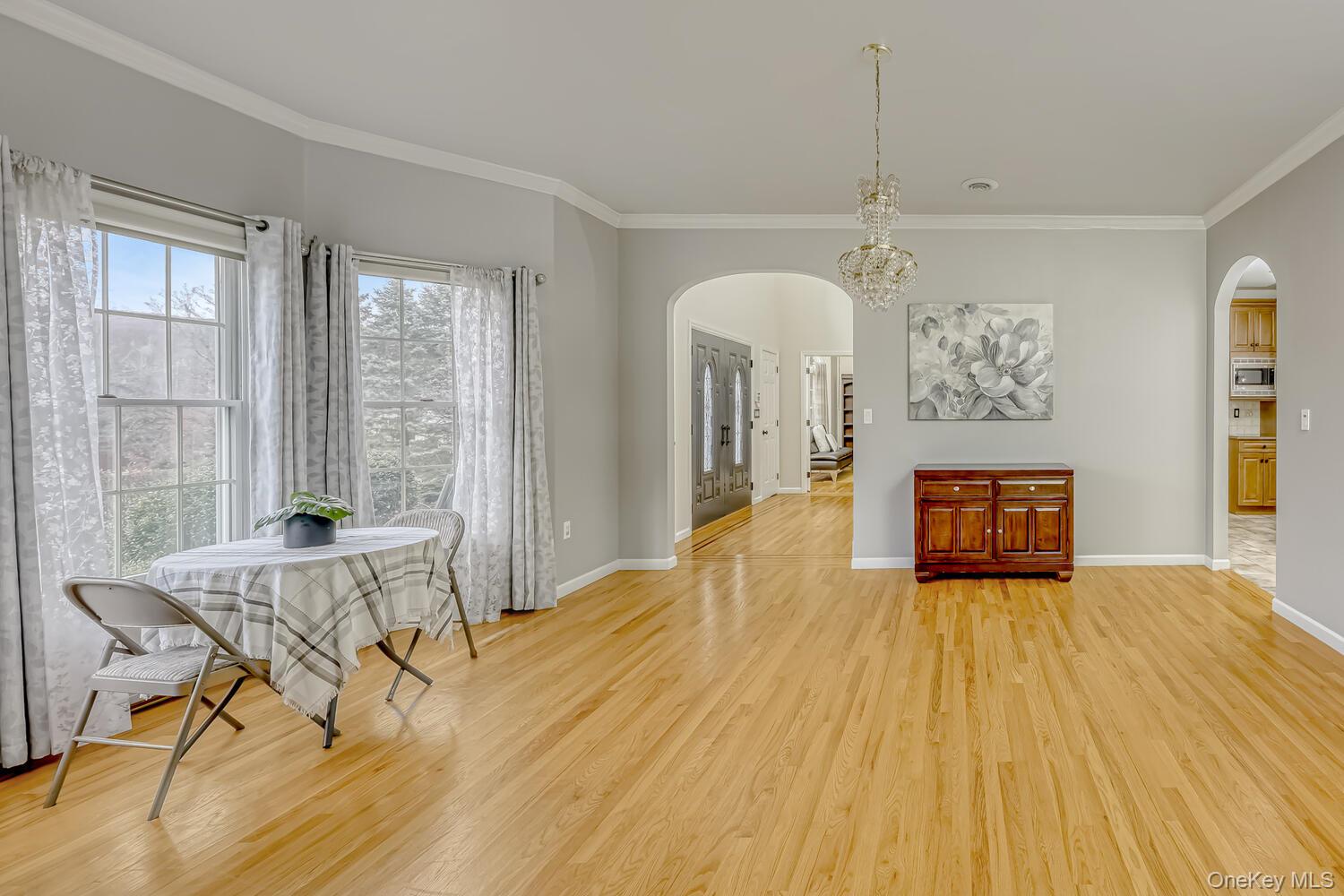22 Golden Road Suffern, NY 10901 - Photo 14 of 41 Dining space featuring ornamental molding, arched walkways, and light wood finished floors