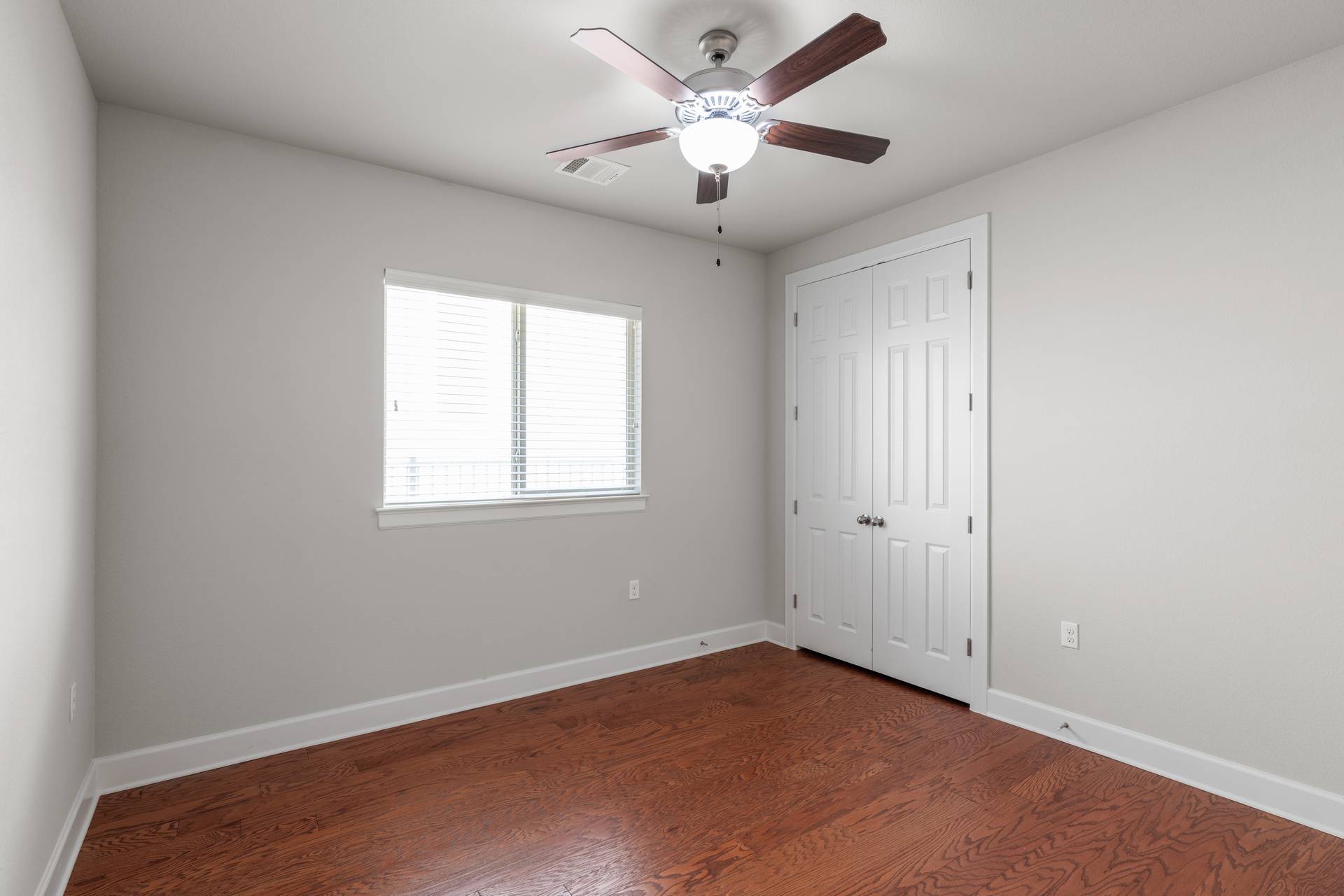 3516 Venezia View Leander, TX 78641 - Photo 20 of 40 Unfurnished bedroom featuring dark wood-type flooring, ceiling fan, and a closet