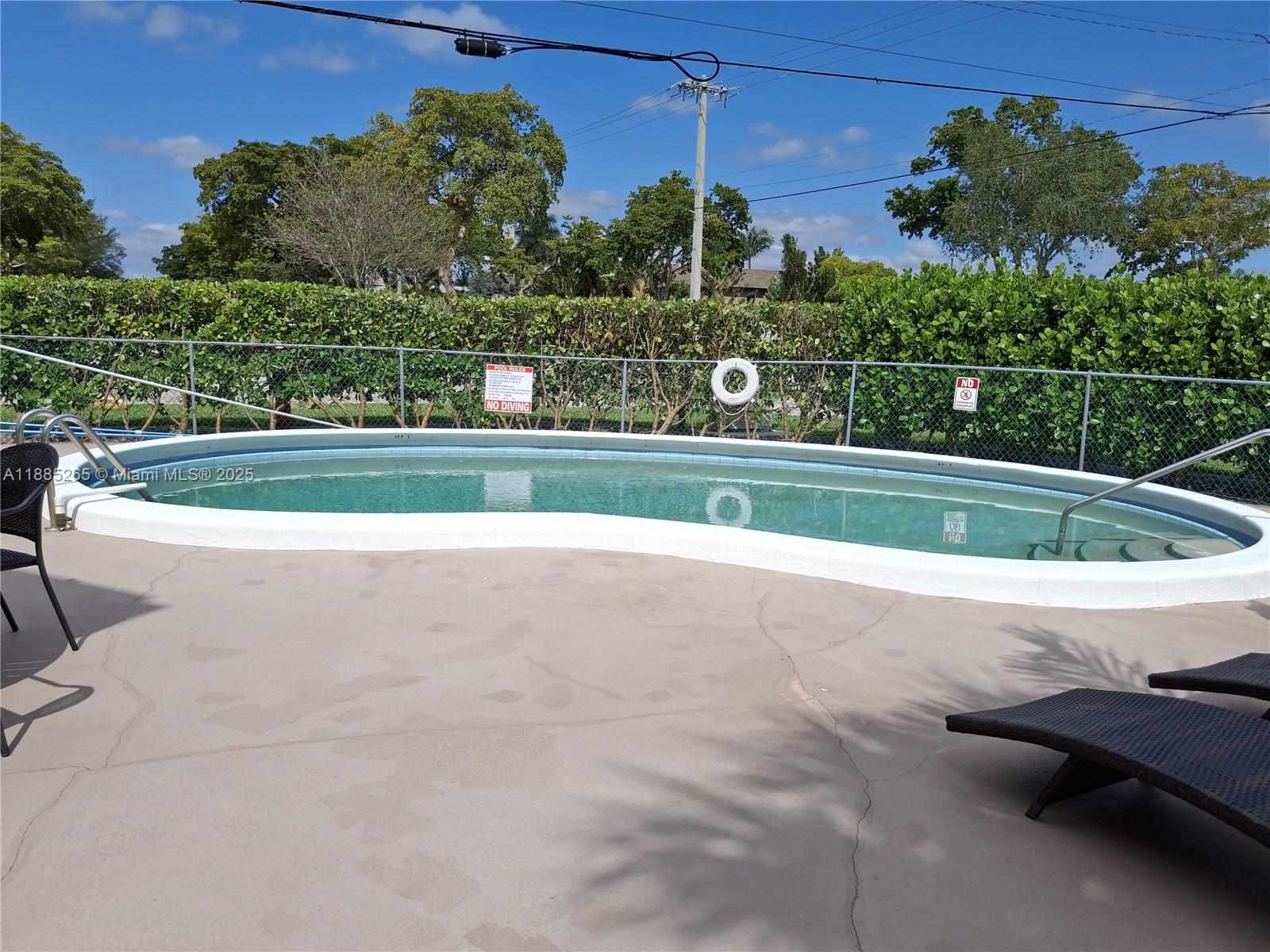5050 Bayview Drive, Unit 20 Fort Lauderdale, FL 33308 - Photo 2 of 10 a view of a yard with a bench