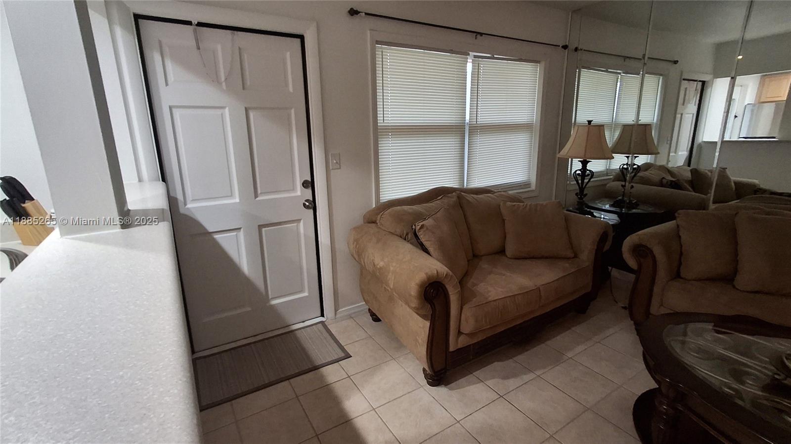 5050 Bayview Drive, Unit 20 Fort Lauderdale, FL 33308 - Photo 4 of 10 a living room with furniture and a window