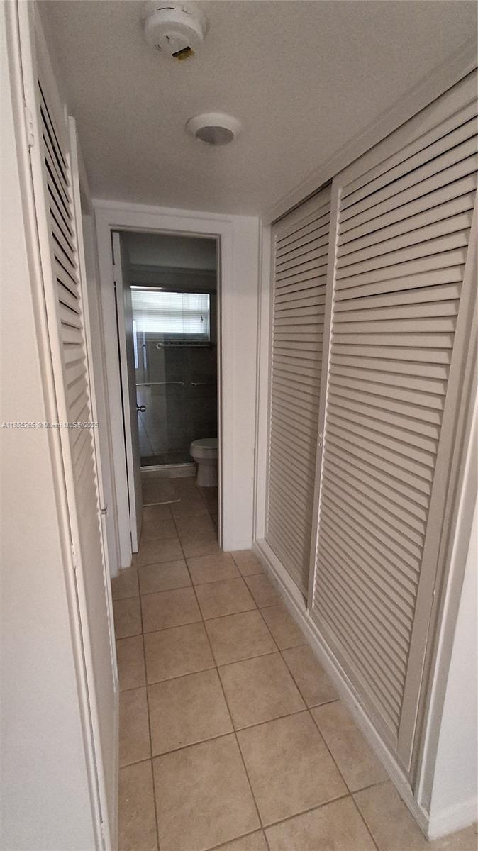5050 Bayview Drive, Unit 20 Fort Lauderdale, FL 33308 - Photo 6 of 10 a view of a hallway and a bathroom with a sink