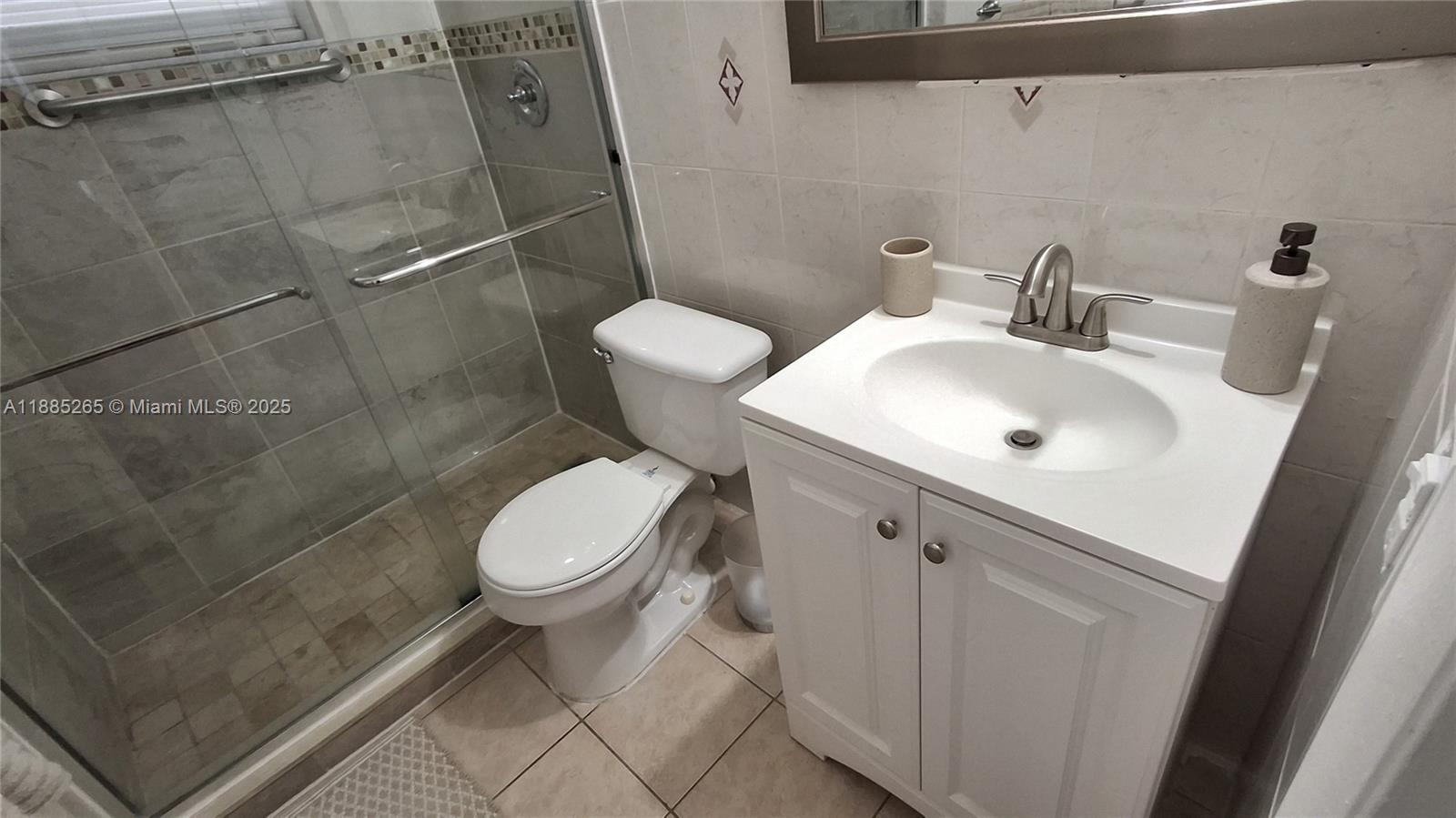 5050 Bayview Drive, Unit 20 Fort Lauderdale, FL 33308 - Photo 7 of 10 a white toilet sitting next to a bathroom sink