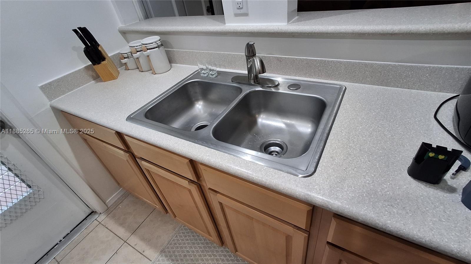 5050 Bayview Drive, Unit 20 Fort Lauderdale, FL 33308 - Photo 10 of 10 a kitchen with a sink and a stove with white cabinets