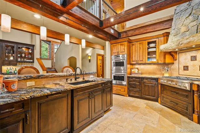 a kitchen with stainless steel appliances granite countertop a sink and a counter