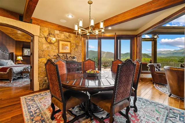 a dining room with furniture and a chandelier