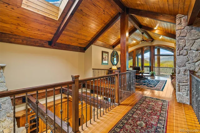 a living room with furniture a rug and a clock