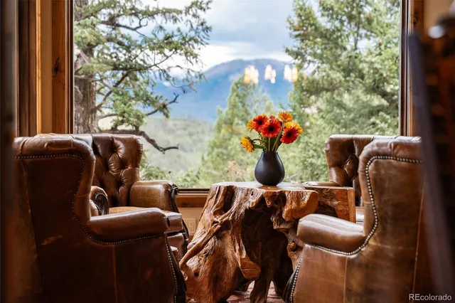 a living room with furniture and flowers