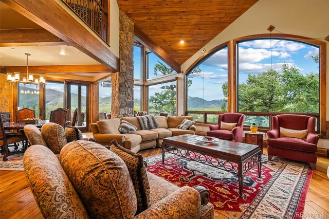 a living room with furniture a large window and a rug