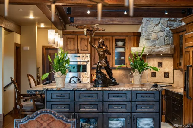 a kitchen with stainless steel appliances granite countertop a stove and cabinets