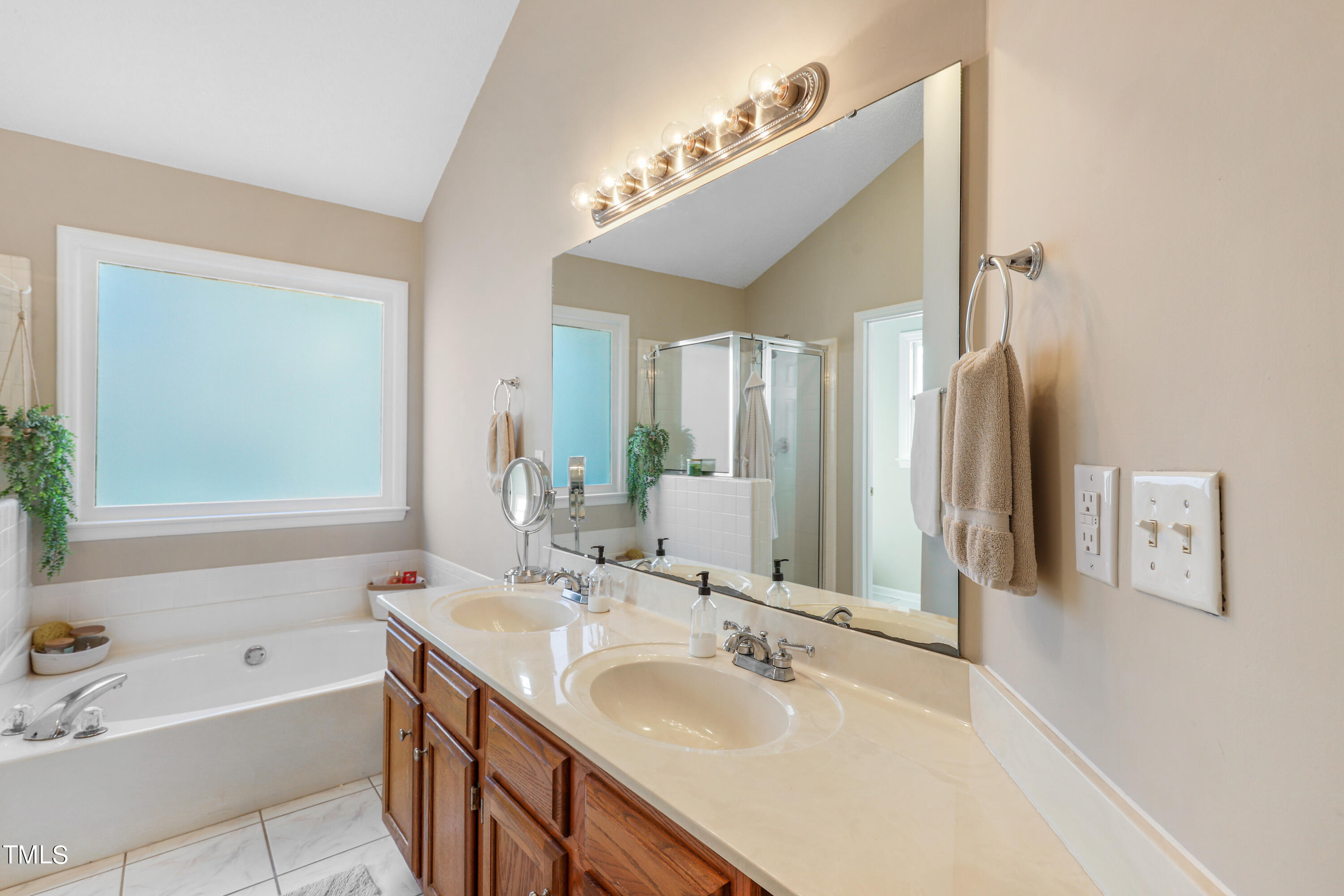 3632 Epperly Court Raleigh, NC 27616 - Photo 13 of 26 a bathroom with a tub a sink and mirror