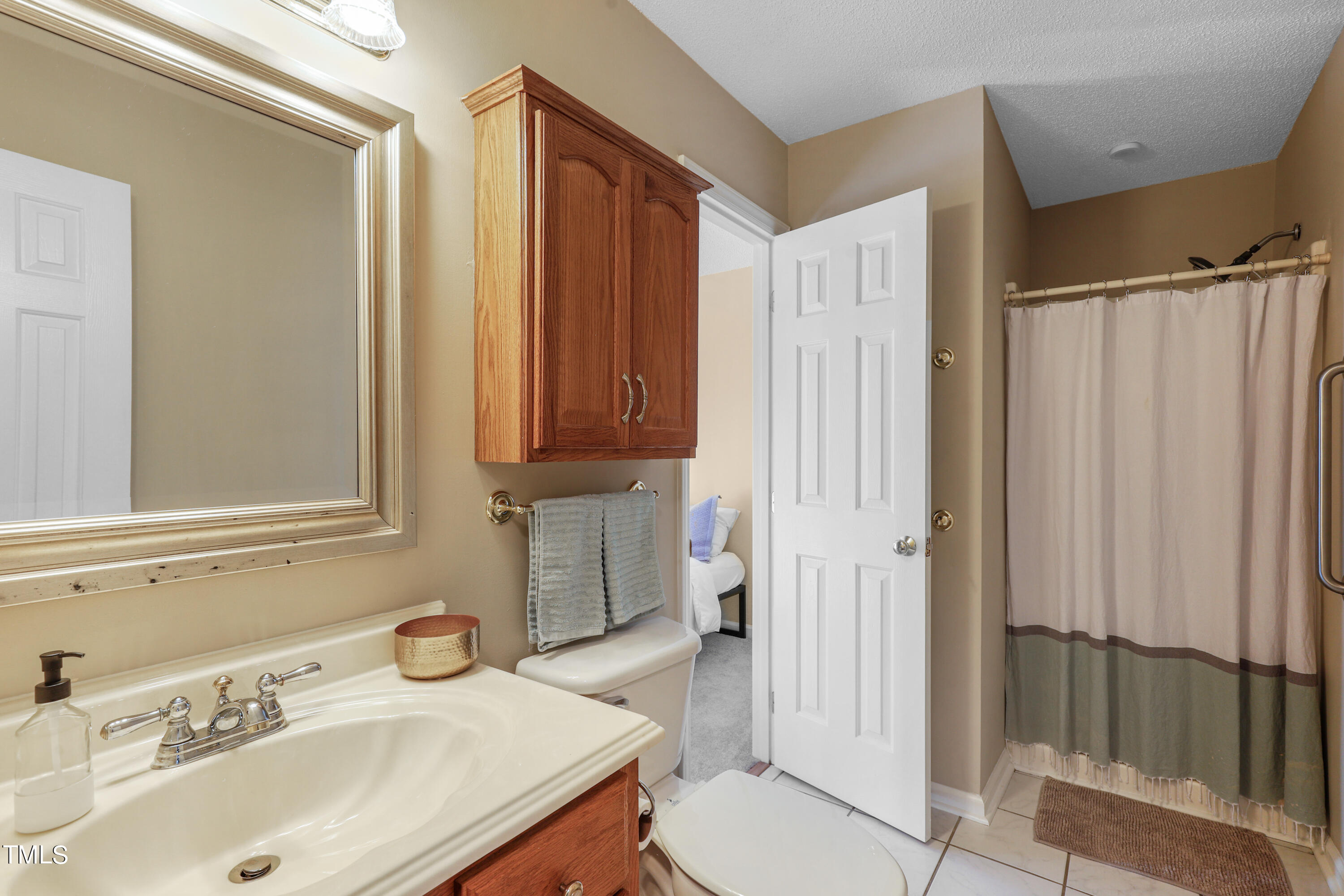 3632 Epperly Court Raleigh, NC 27616 - Photo 17 of 26 a bathroom with a sink a toilet and shower