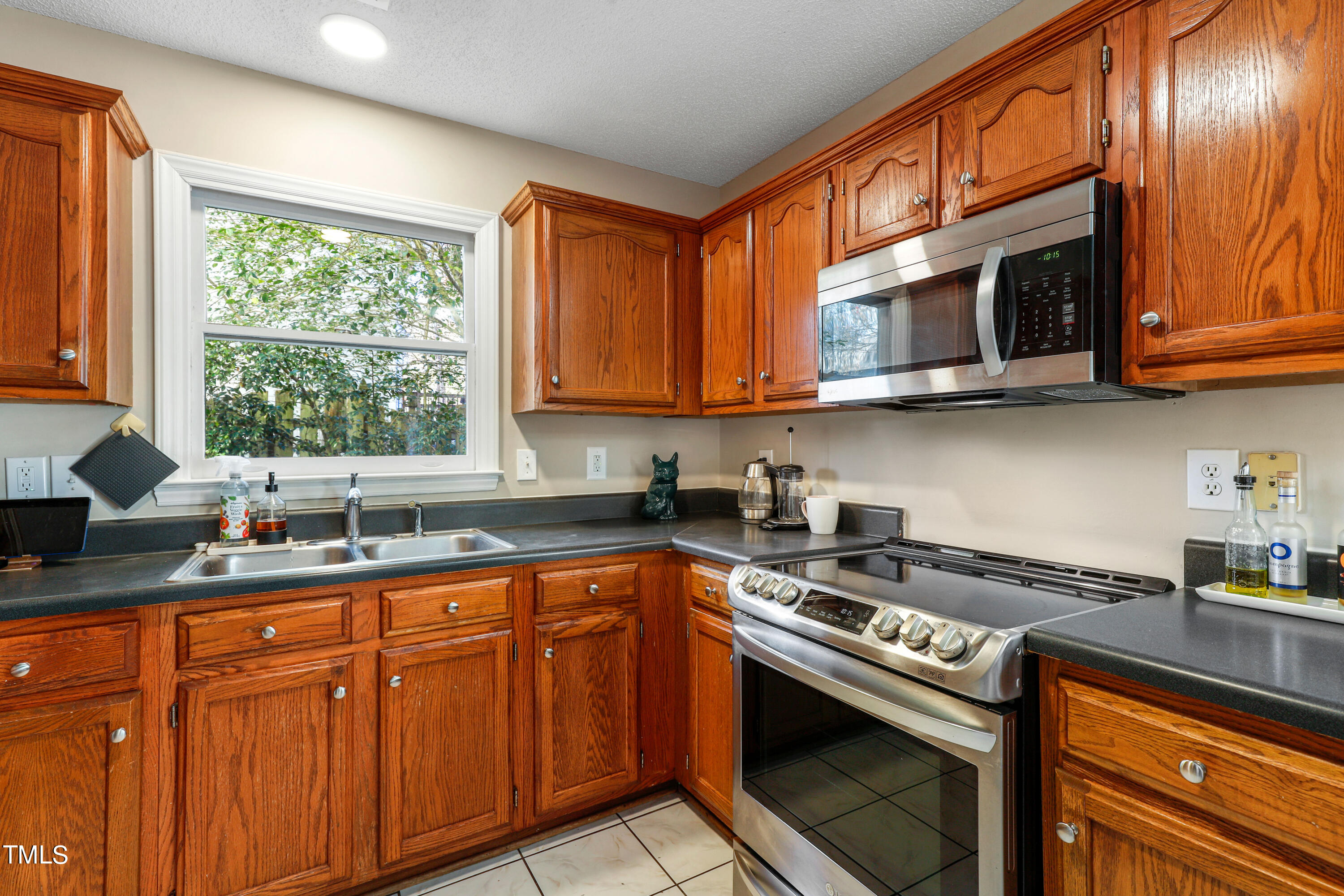 3632 Epperly Court Raleigh, NC 27616 - Photo 8 of 26 a kitchen with stainless steel appliances granite countertop a sink a stove and cabinets