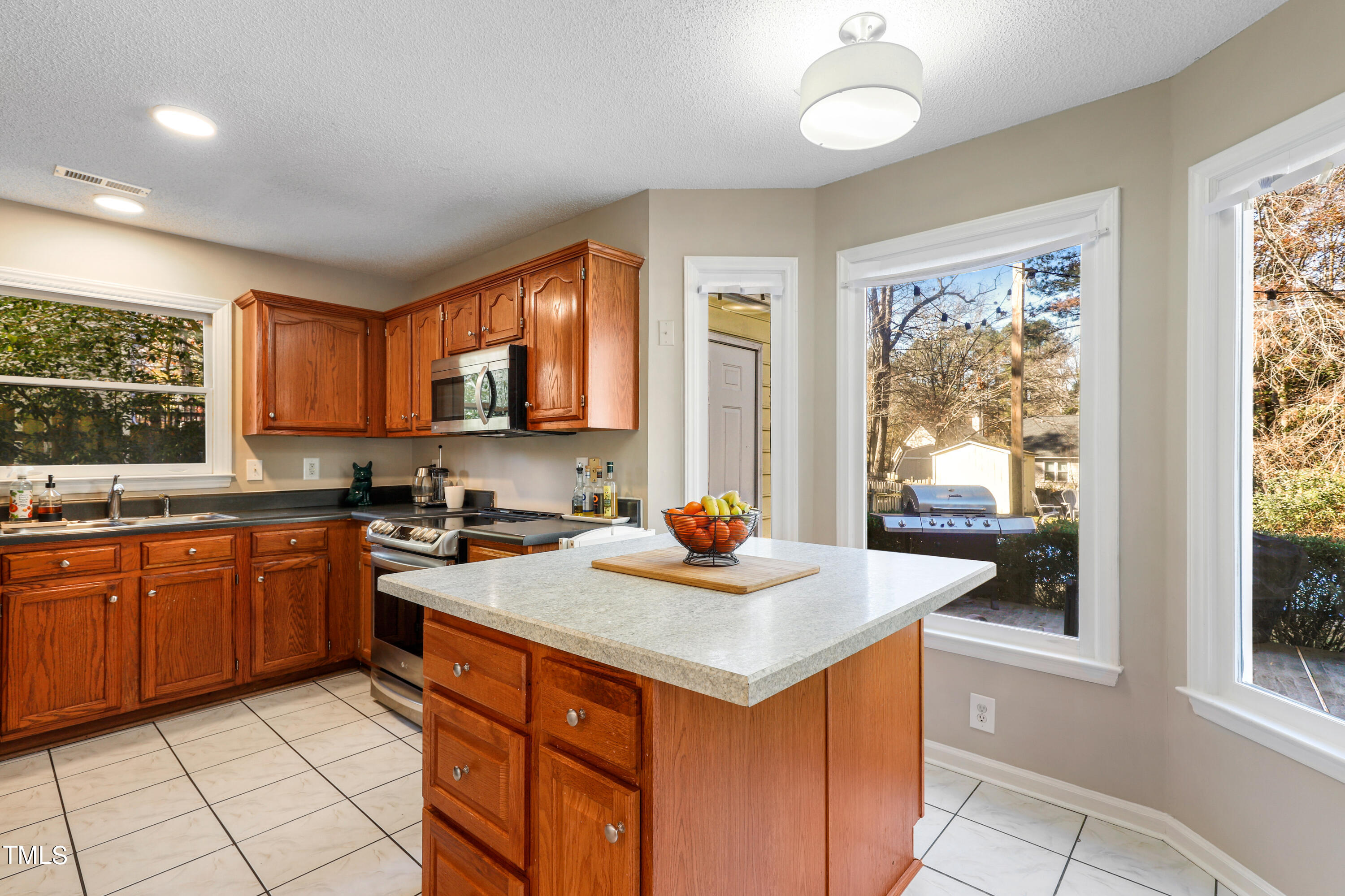 3632 Epperly Court Raleigh, NC 27616 - Photo 9 of 26 a kitchen with sink a stove and chairs